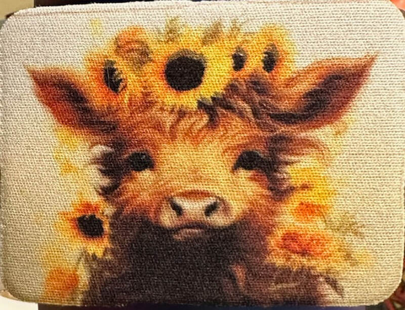 COW PLAYING WITH SUNFLOWERS