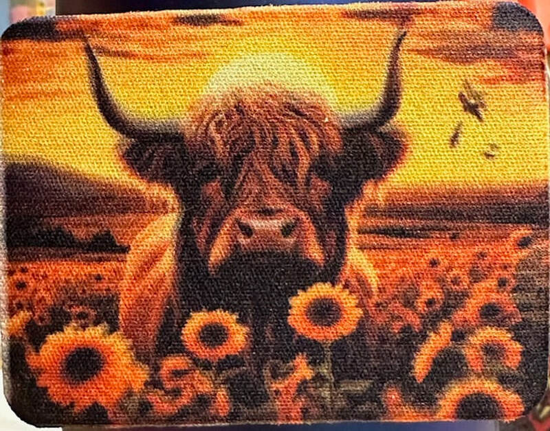 HIGHLAND COW IN THE SUNFLOWERS AT SUNSET